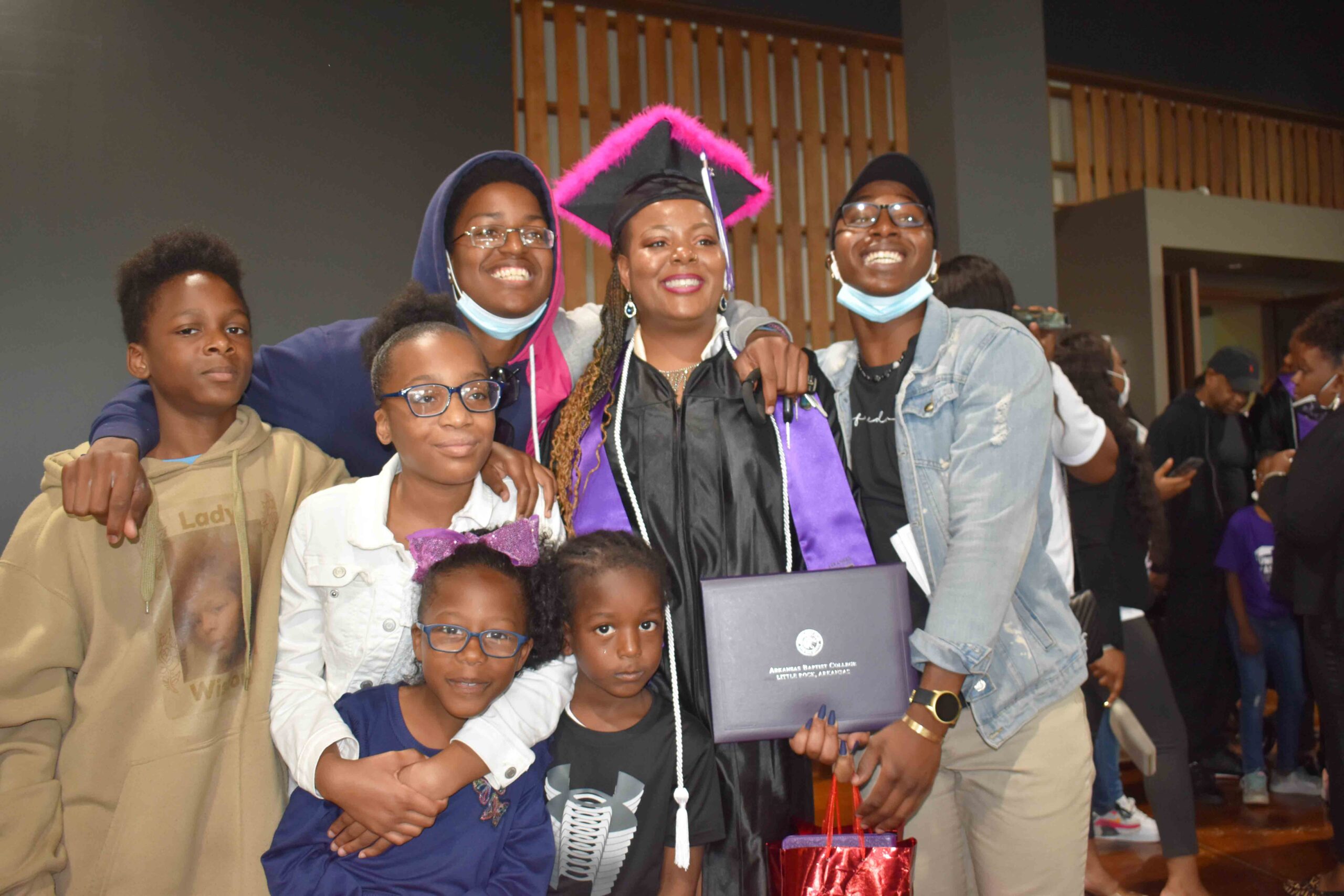 Honor graduate, Gussie Harris is congratulated by her children